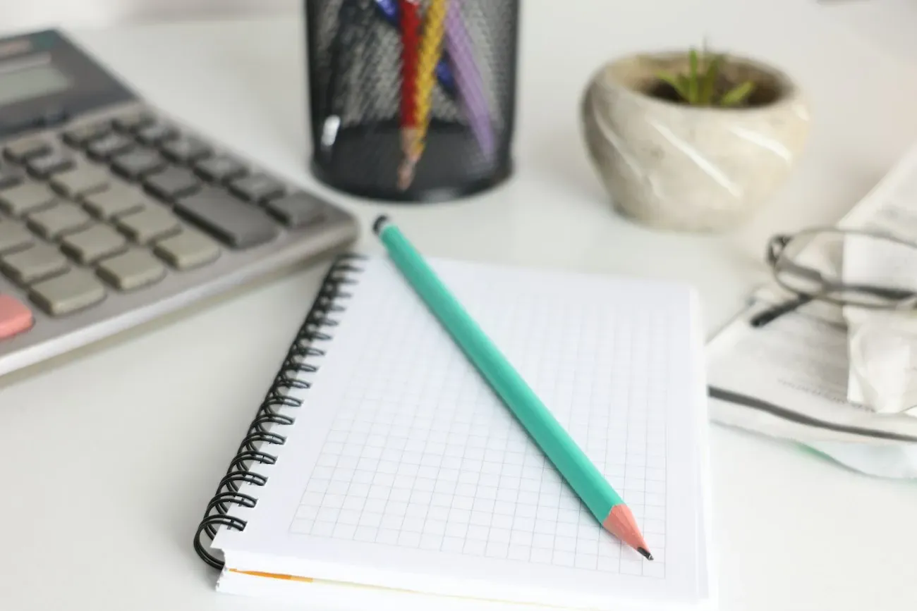 Calculator beside an open planning notebook