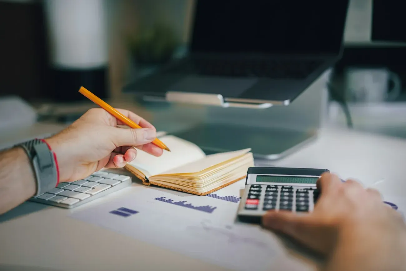 A desk with notebook and calculator