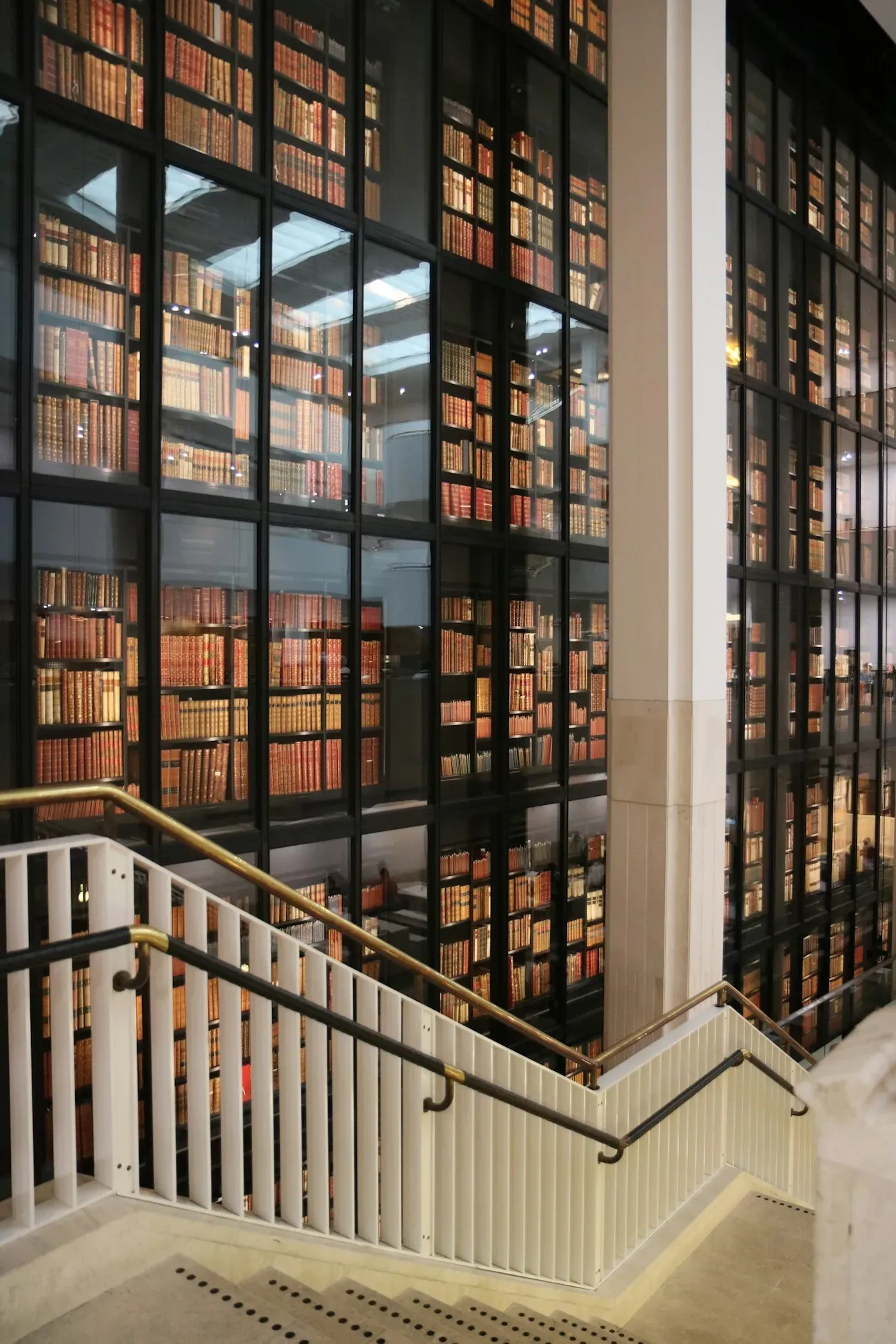 Staircase beside library shelves
