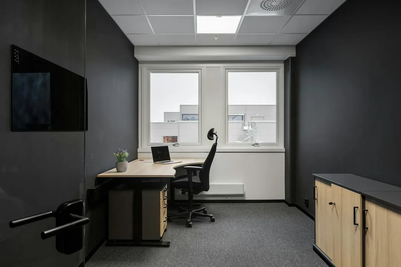 A quiet workspace with computers and chairs